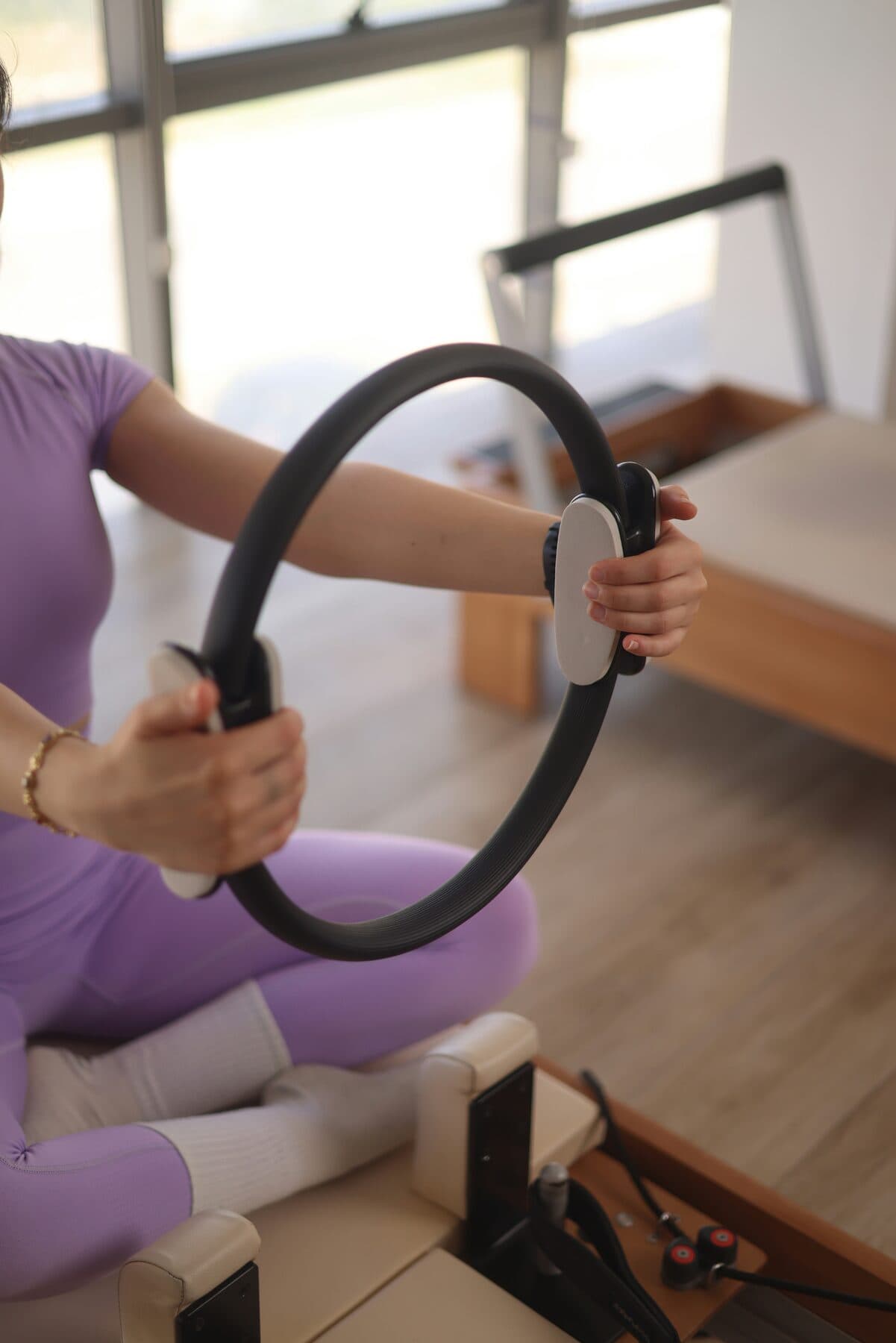 A reformer Pilates session in a bright studio