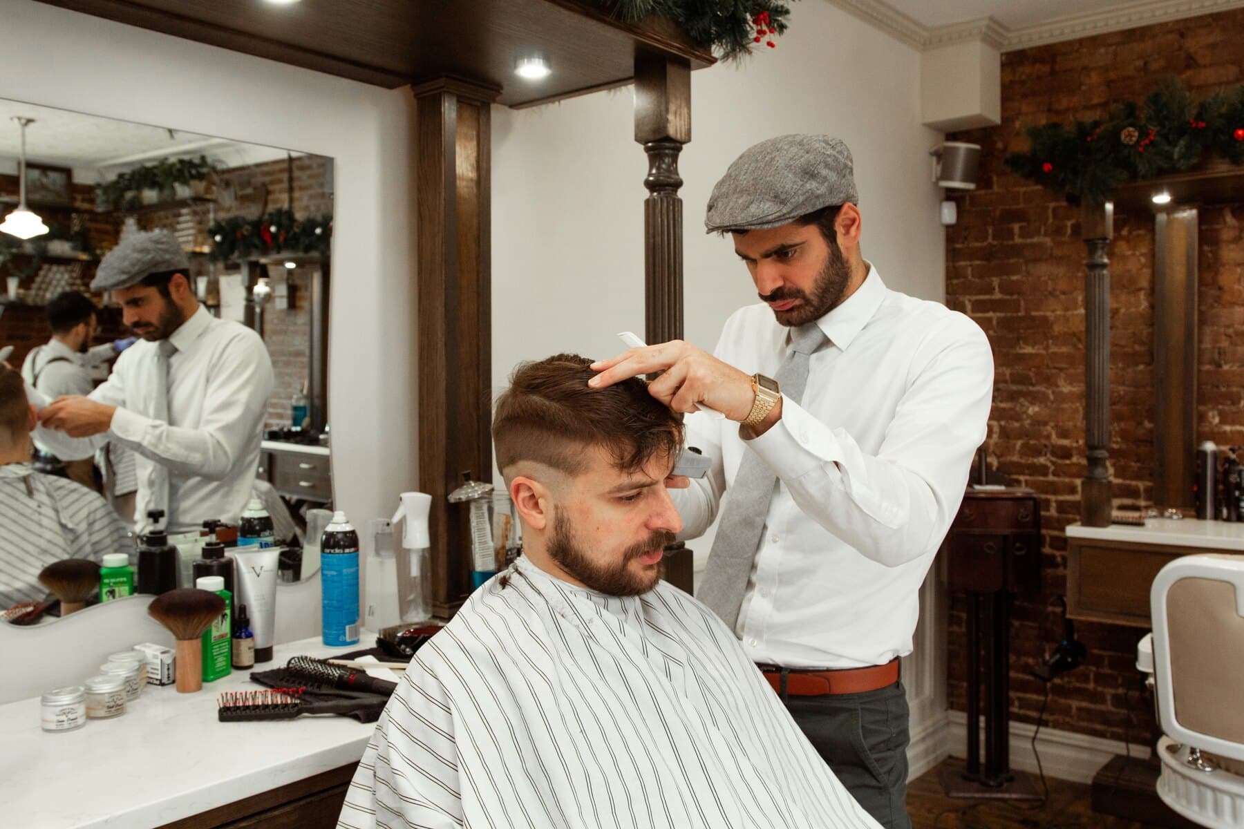 A stylist working with a client in a salon chair